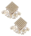 This image displays a pair of elegant pearl earrings, referred to as "Pearl Mids." The earrings feature a sophisticated design, with each earring composed of a shimmering pearl surface, meticulously arranged in a grid-like pattern, and embellished with delicate, small, white beads.