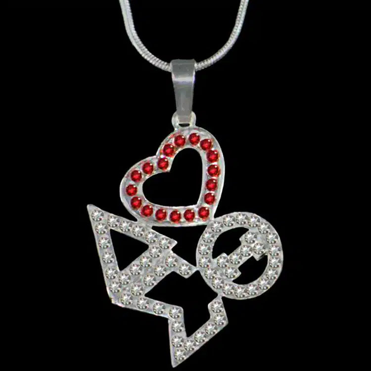 Pendant with heart and arrow design on a black background