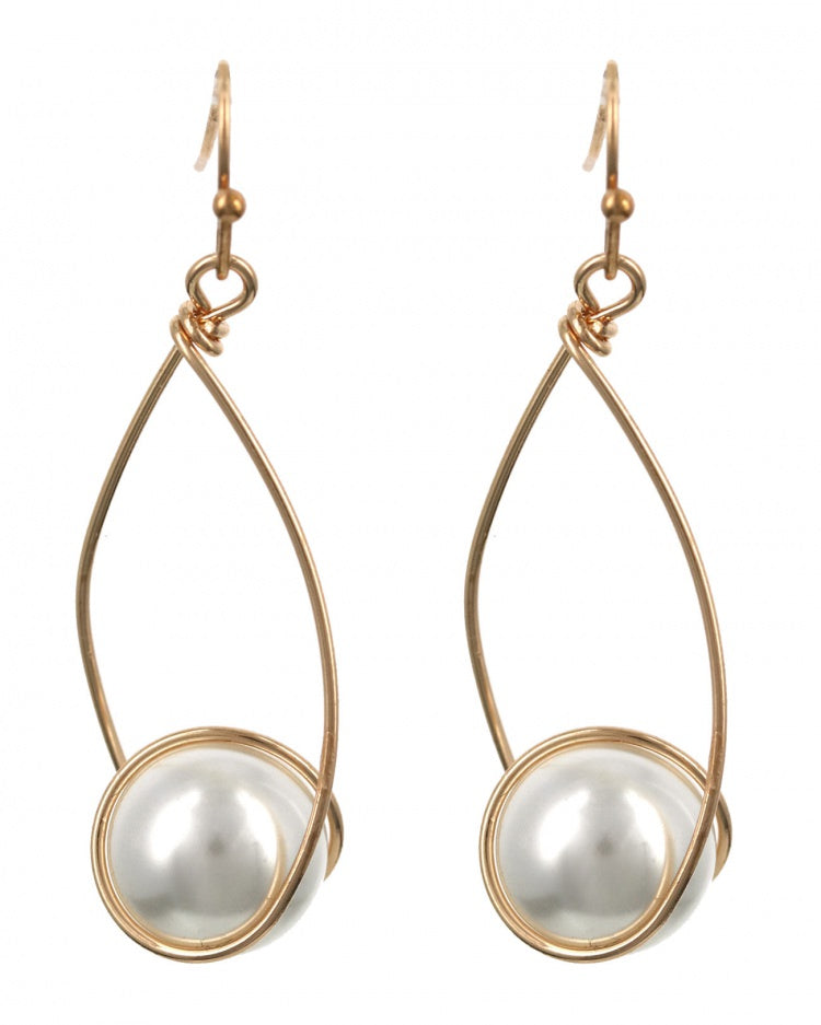Gold-framed earrings with white pearls on a white background