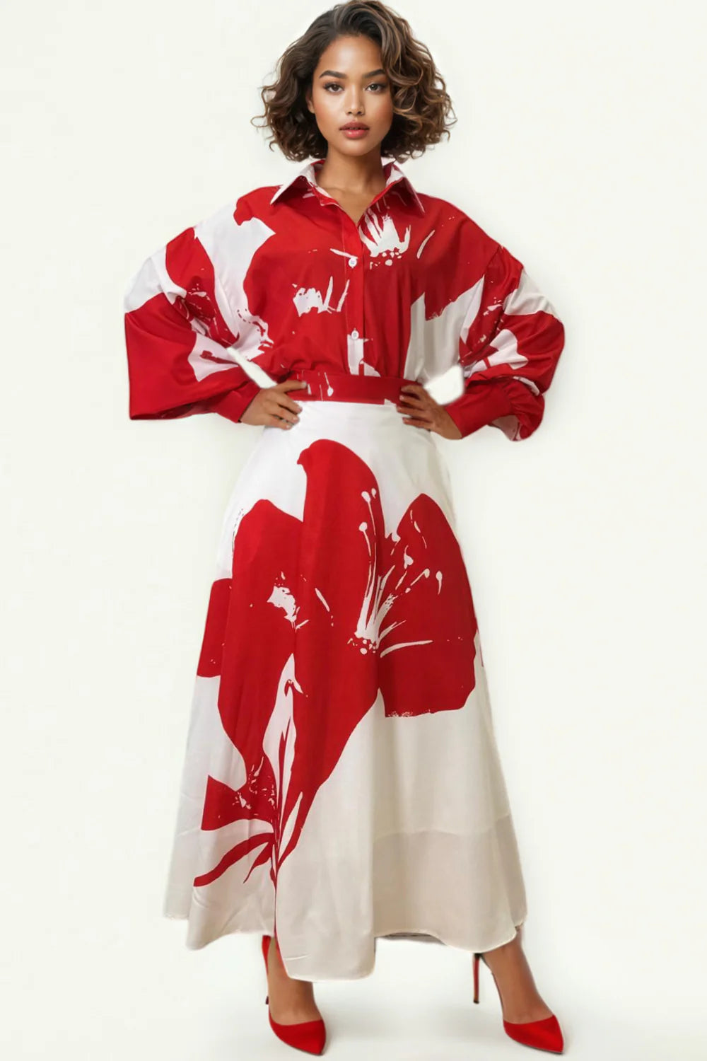 A model wearing a red and white button-down maxi skirt set with pockets and a classic collar, paired with long cuffed sleeves.