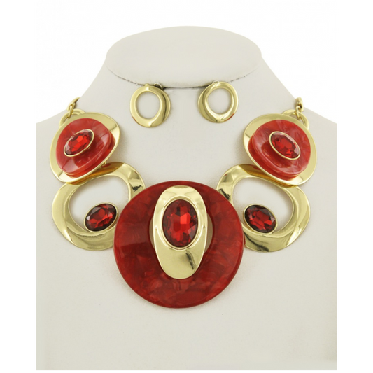 Jewelry set with red and gold circular designs on a white stand