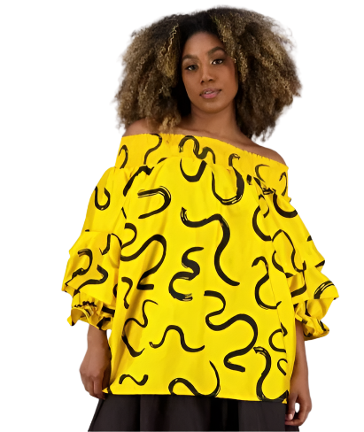Woman wearing a yellow off-shoulder top with black snake patterns on a white background