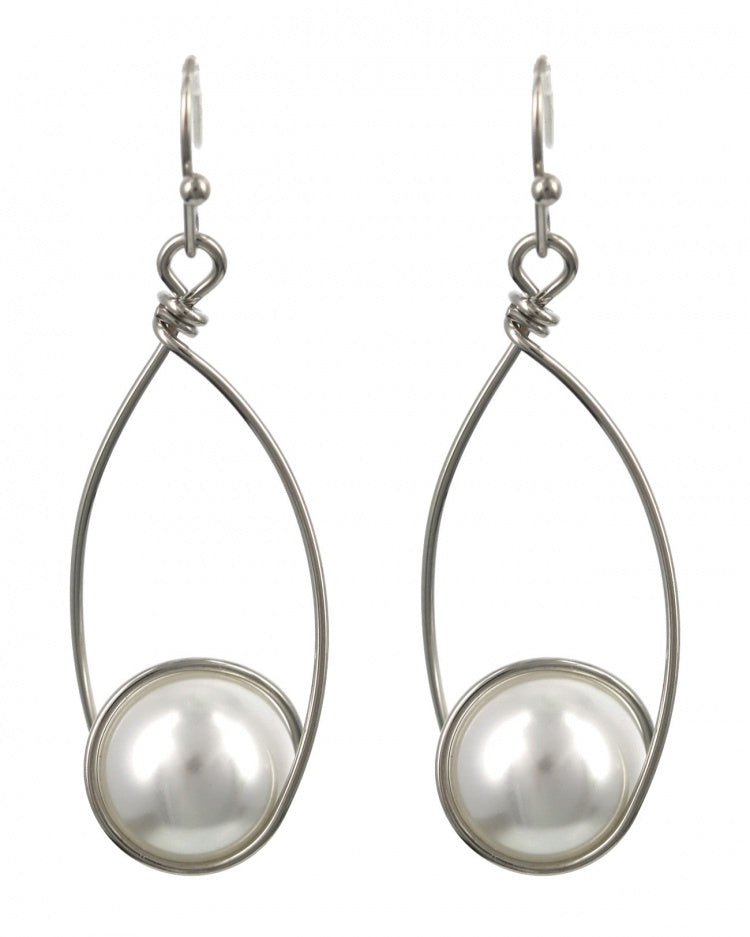 Pair of silver earrings with pearl-like beads on a white background