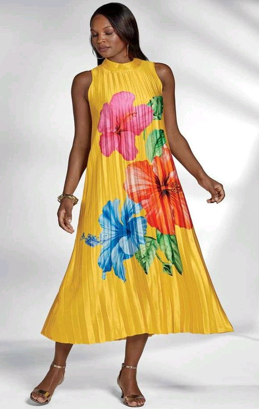 Woman wearing a yellow dress with colorful floral patterns on a white background