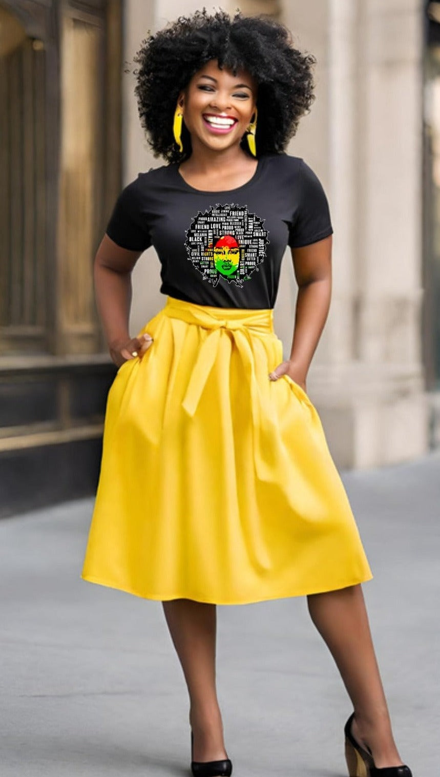 a women wearing a short sleeve black t-shirt with a afro filled with many words, friend, justice, smart, love, proud, amazing, unique, strong, etc with Africa in red black and green in the background
