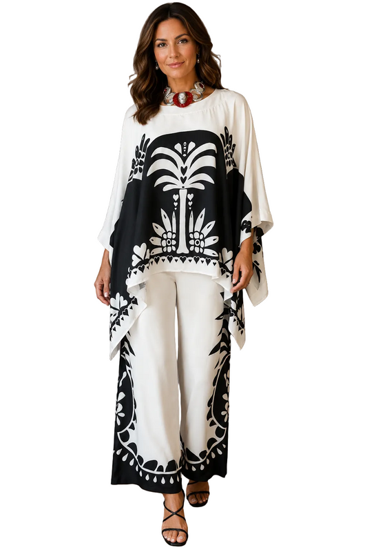 Woman wearing a black and white patterned outfit against a plain background