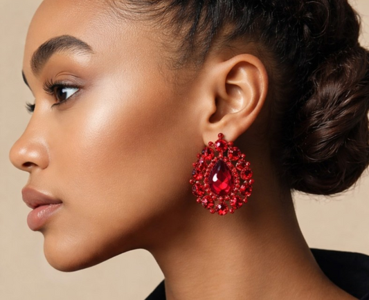 Woman wearing red earrings with a neutral background