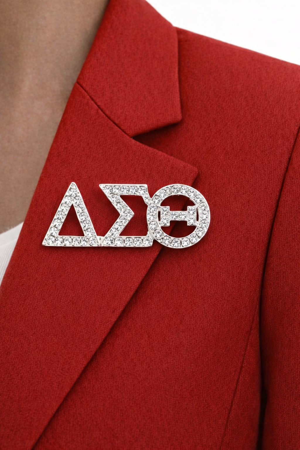 Silver Delta Sigma Theta sorority pin on a red blazer