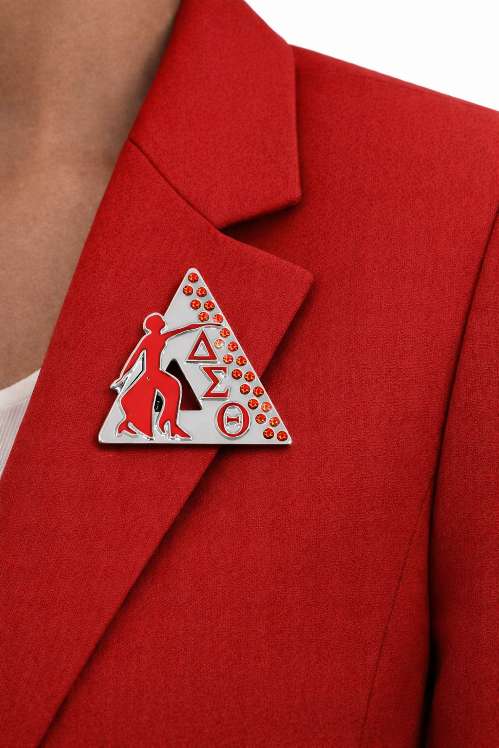 Red blazer with a decorative pin featuring DST symbols and a couple.