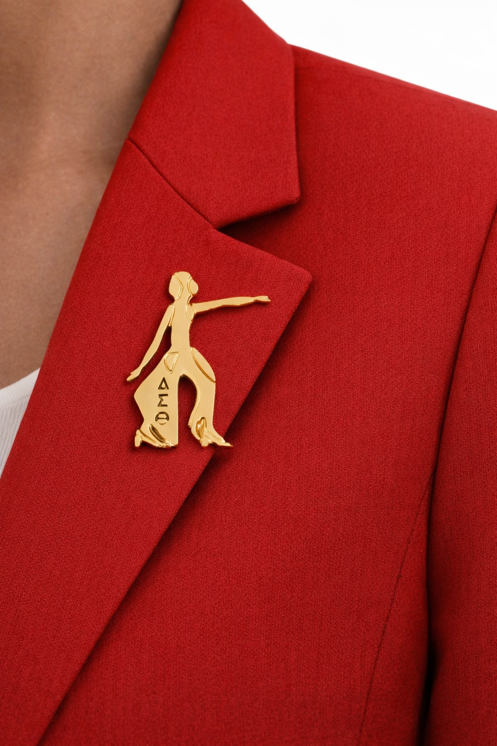 Red blazer with a gold brooch featuring a dancer on a white background