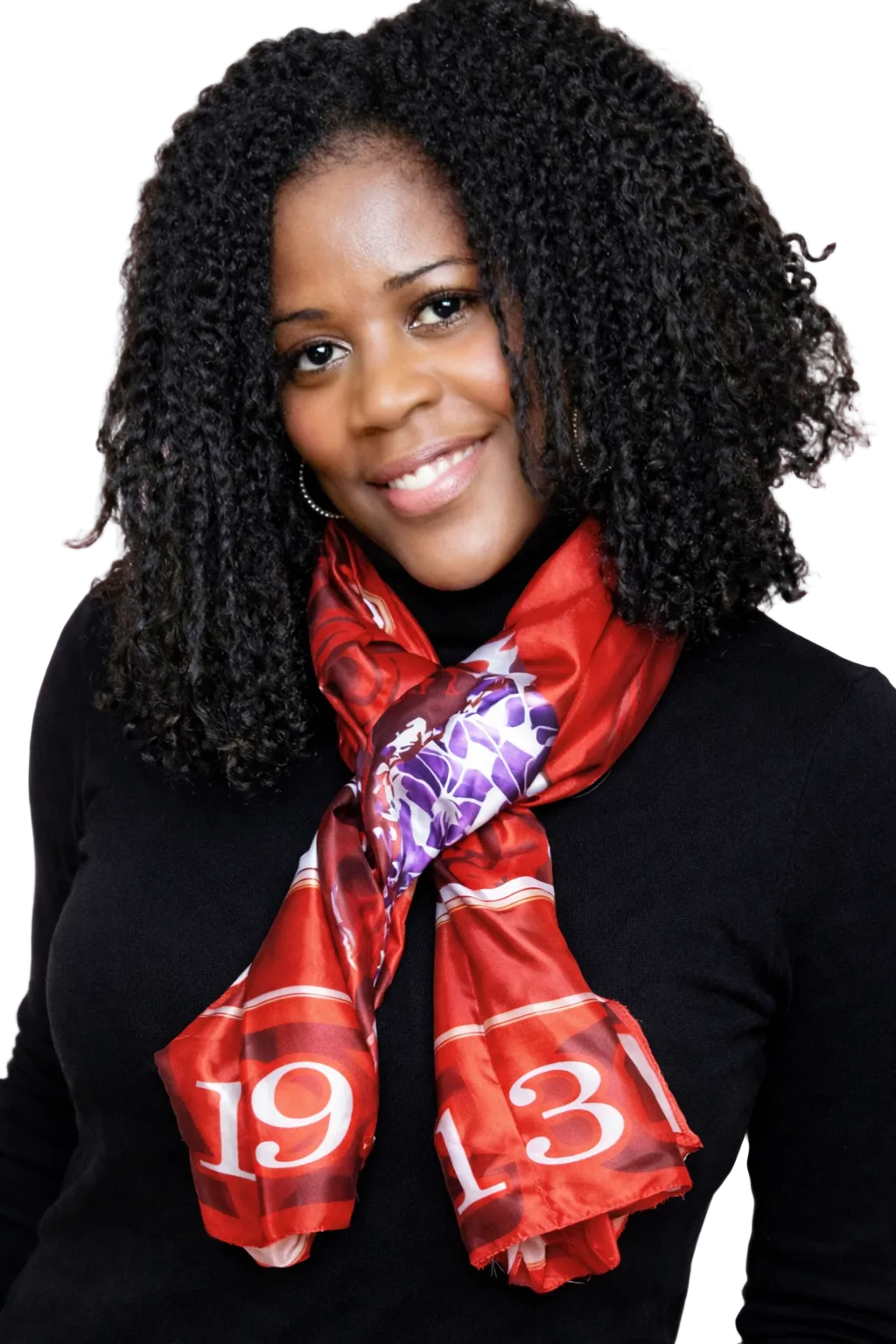 Woman wearing a red scarf with a pattern, against a pink background
