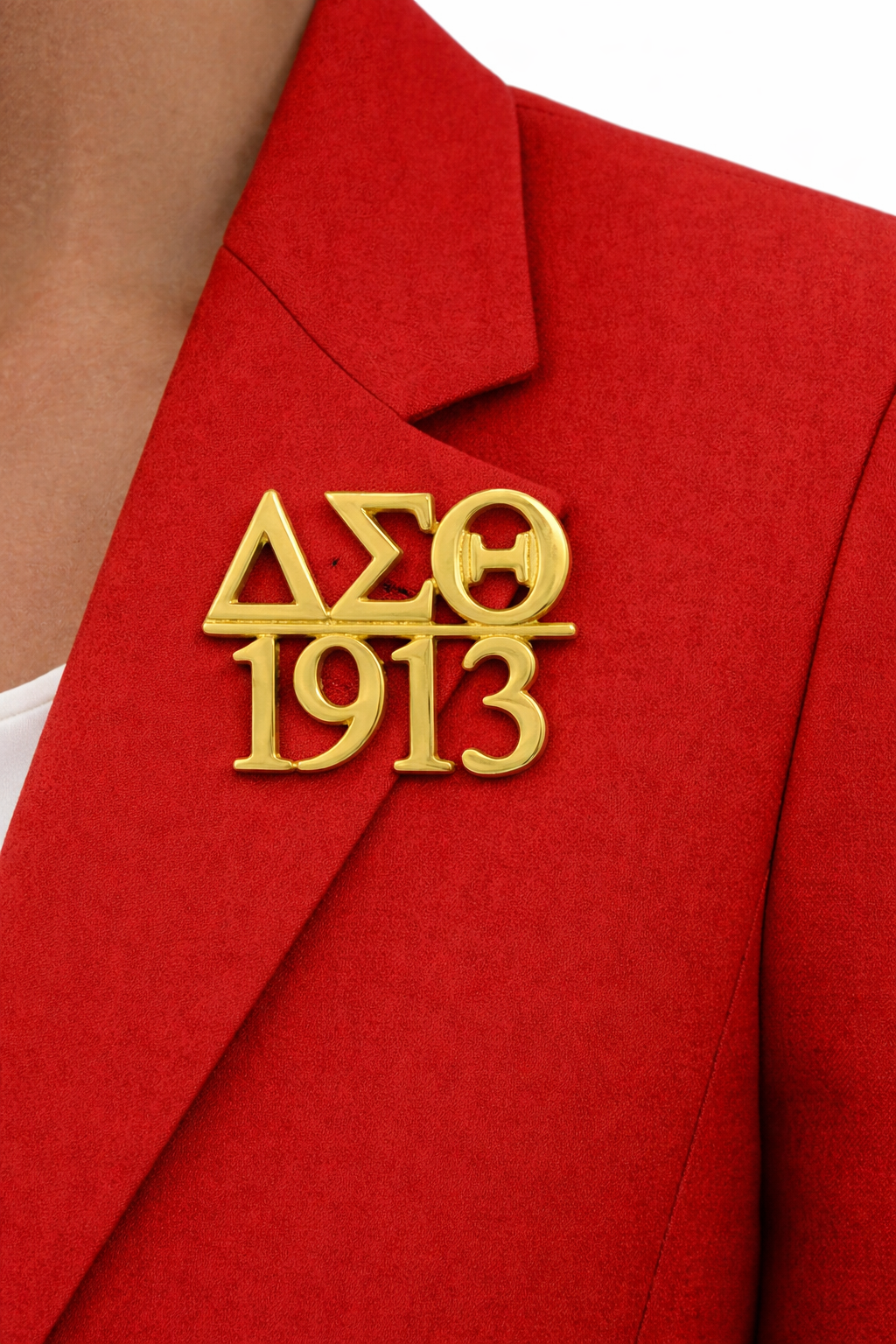 Gold Delta Sigma Theta sorority pin on a red jacket