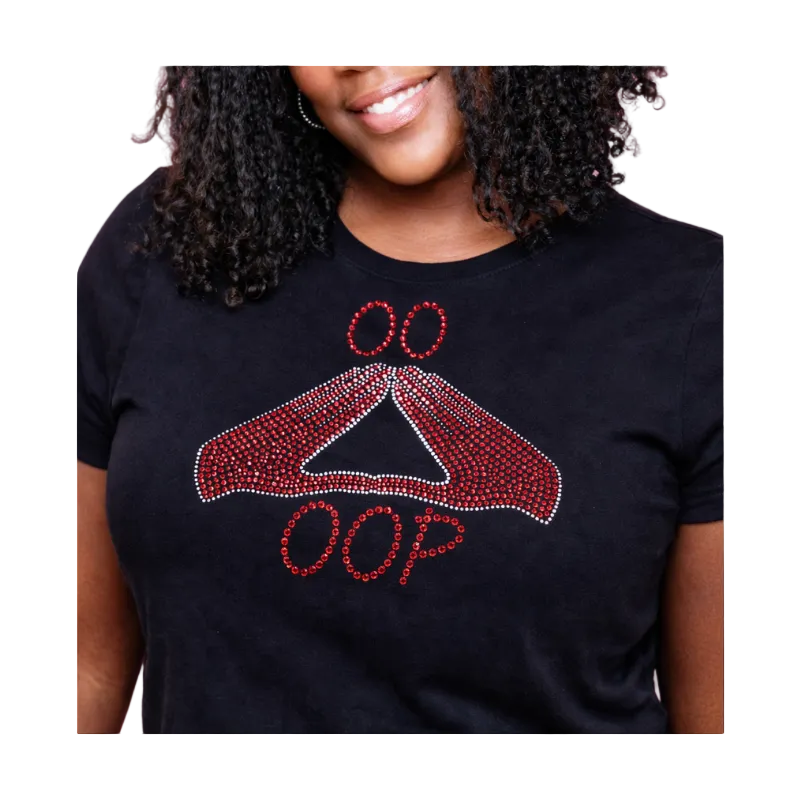 Person wearing a black t-shirt with red rhinestone OO OOP design on a white background