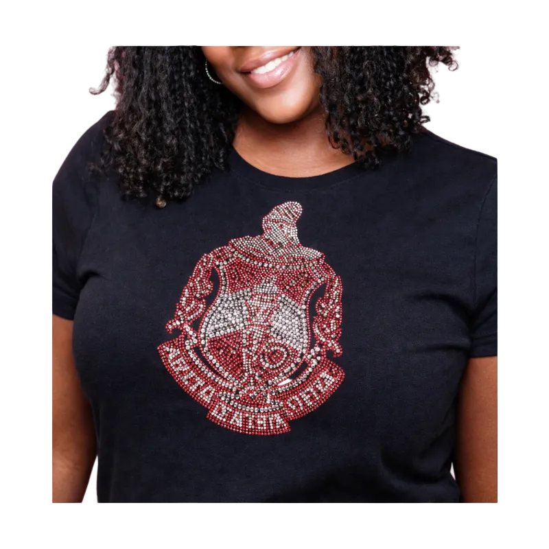 Person wearing a black t-shirt with a red and silver Delta Sigma Theta Crest on a white background