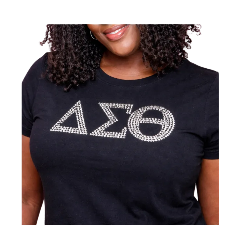 Black t-shirt with white rhinestone-embellished letters worn by a person against a white background