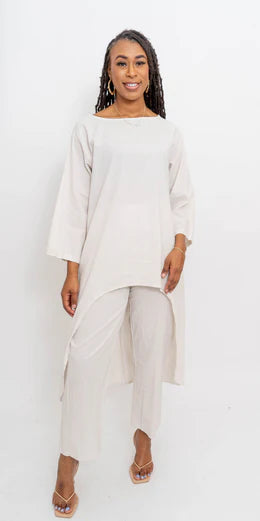 A woman wearing a beige linen look 2-piece pant set with a relaxed-fit top and high-waisted pants.