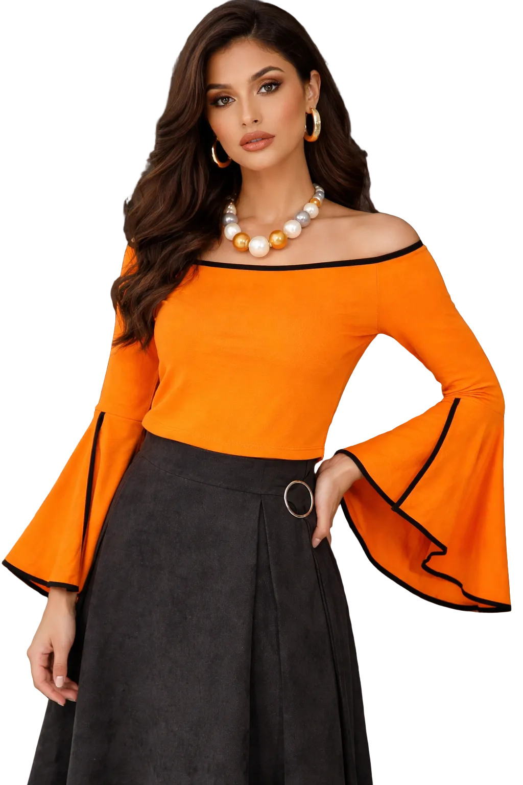 Woman wearing an orange off-shoulder top with black trim and a black skirt, standing against a textured wall.