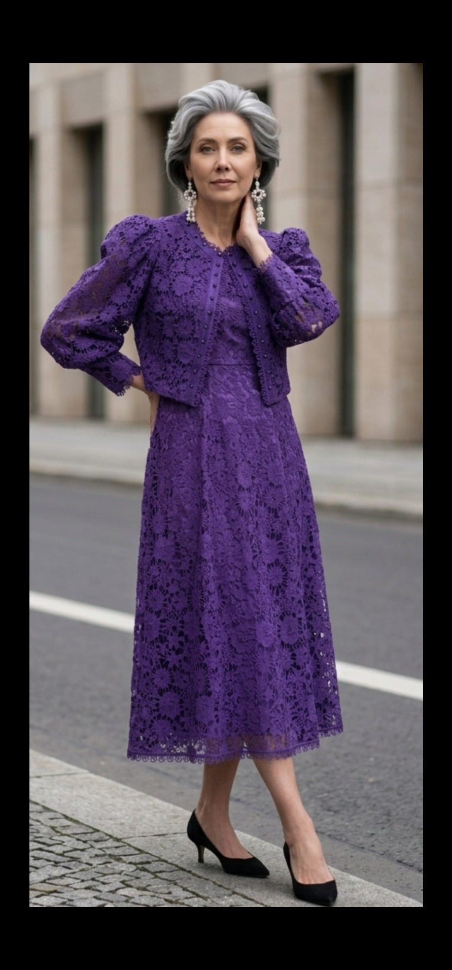 Woman modeling a purple floral lace midi dress with coordinating cropped jacket, puff sleeves, and black pointed-toe pumps.