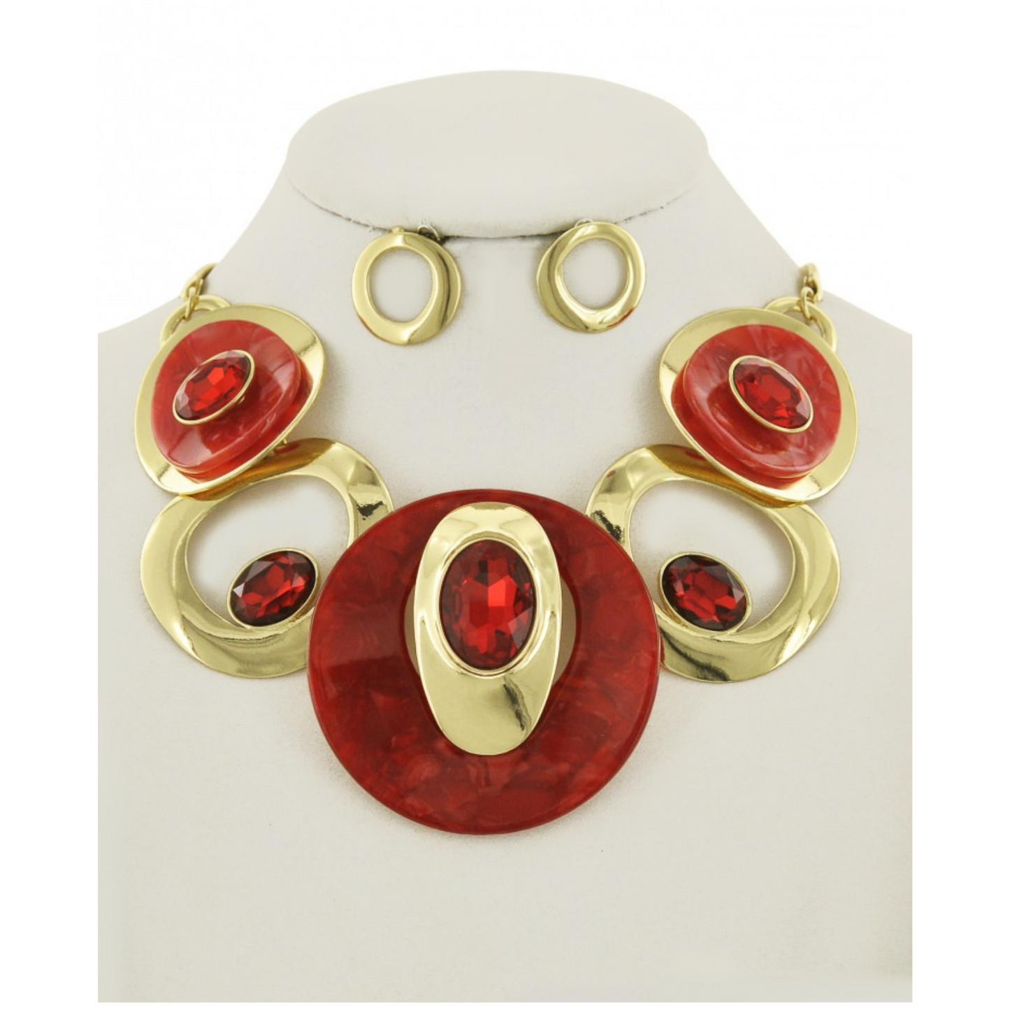 Jewelry set with red and gold circular designs on a white stand