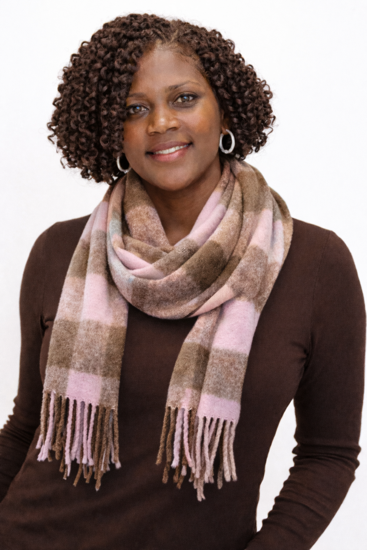 Woman wearing a plaid scarf on a white background
