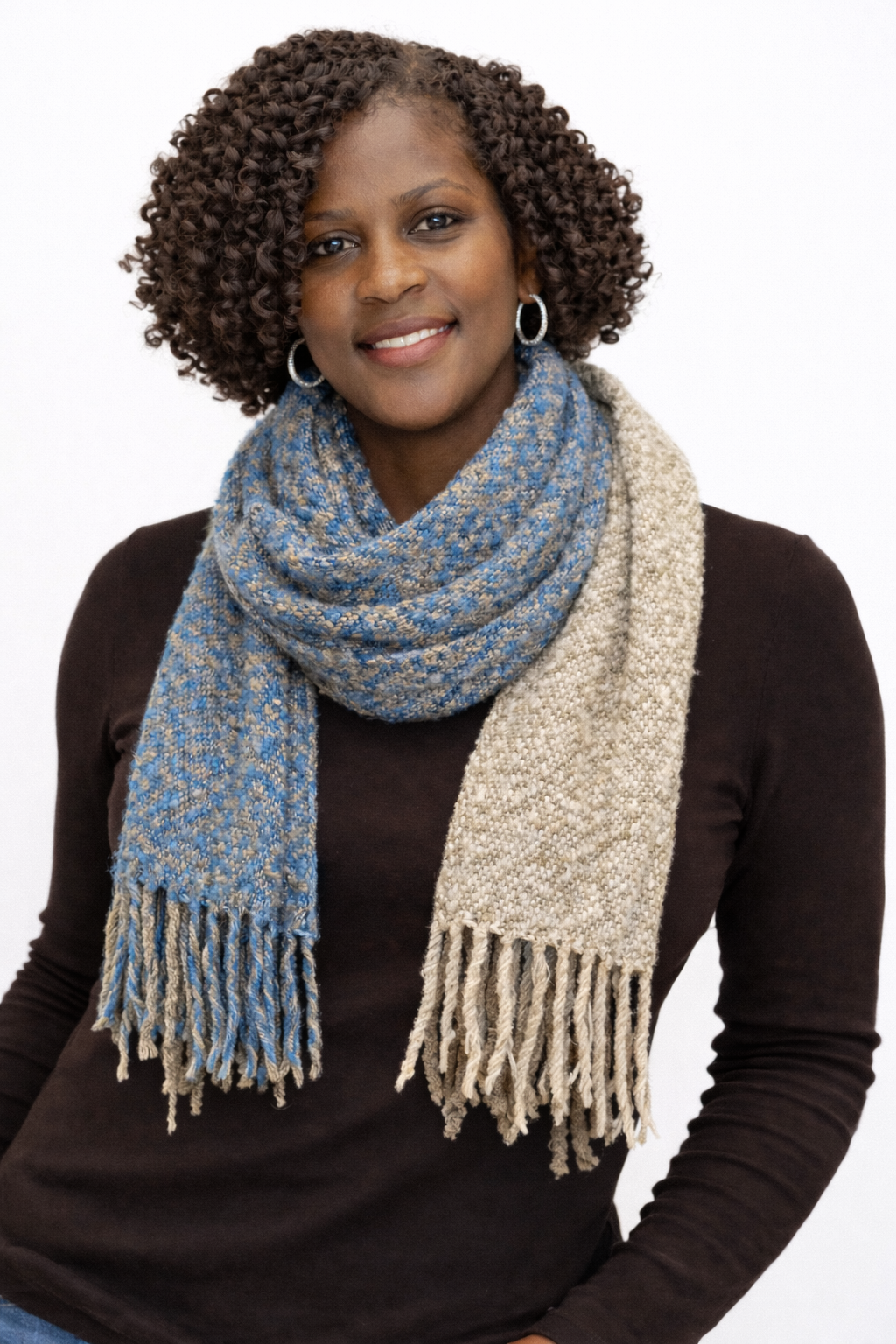 Woman wearing a blue and beige scarf on a white background